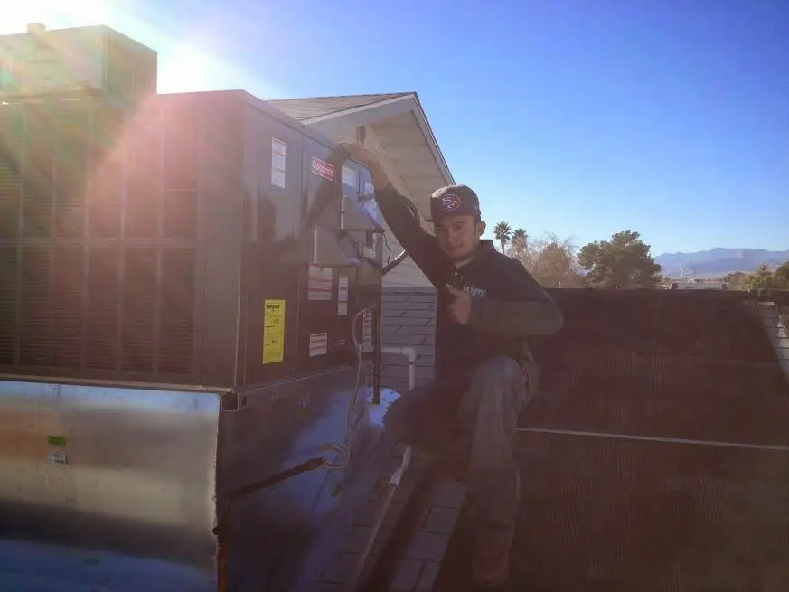 HVAC technician performing HVAC Inspection on a rooftop unit in Superior